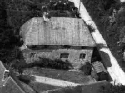 Shepherd's Thatch, an elegant fifteenth century timber-framed house at Nutbourne, West Sussex, pictured before it was restored and reinstated. It is believed that this picture dates from the 1960s.